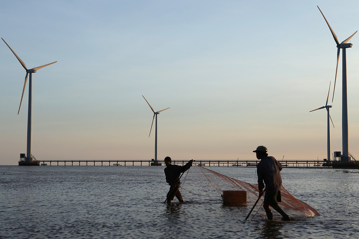 Nelayan dan pembangkit listrik tenaga angin pertama di Vietnam (AFP Photo/Duy Khoi)