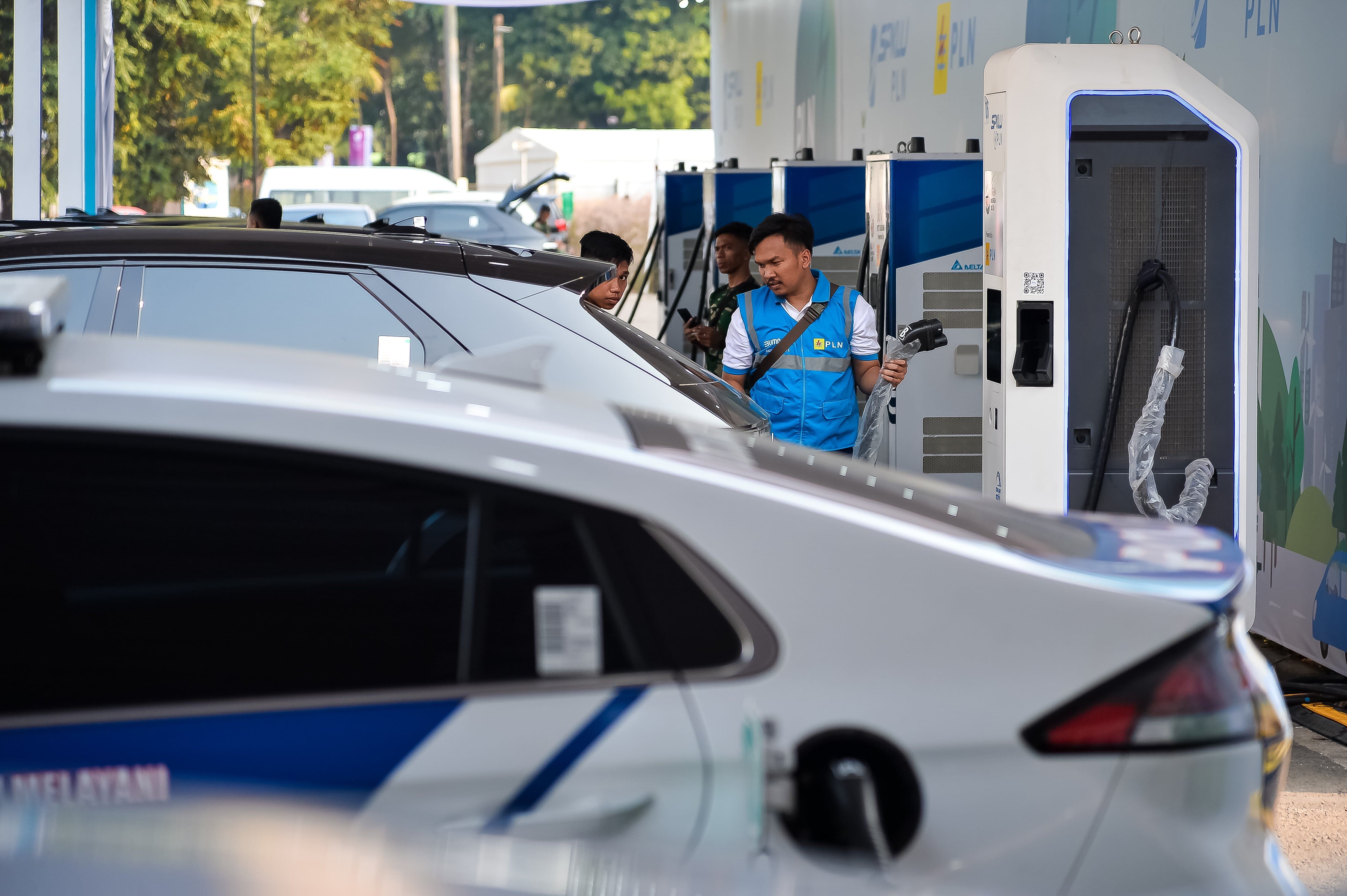 Petugas yang melakukan pengisian terhadap mobil listrik demi kelancaran KTT ASEAN di Jakarta
