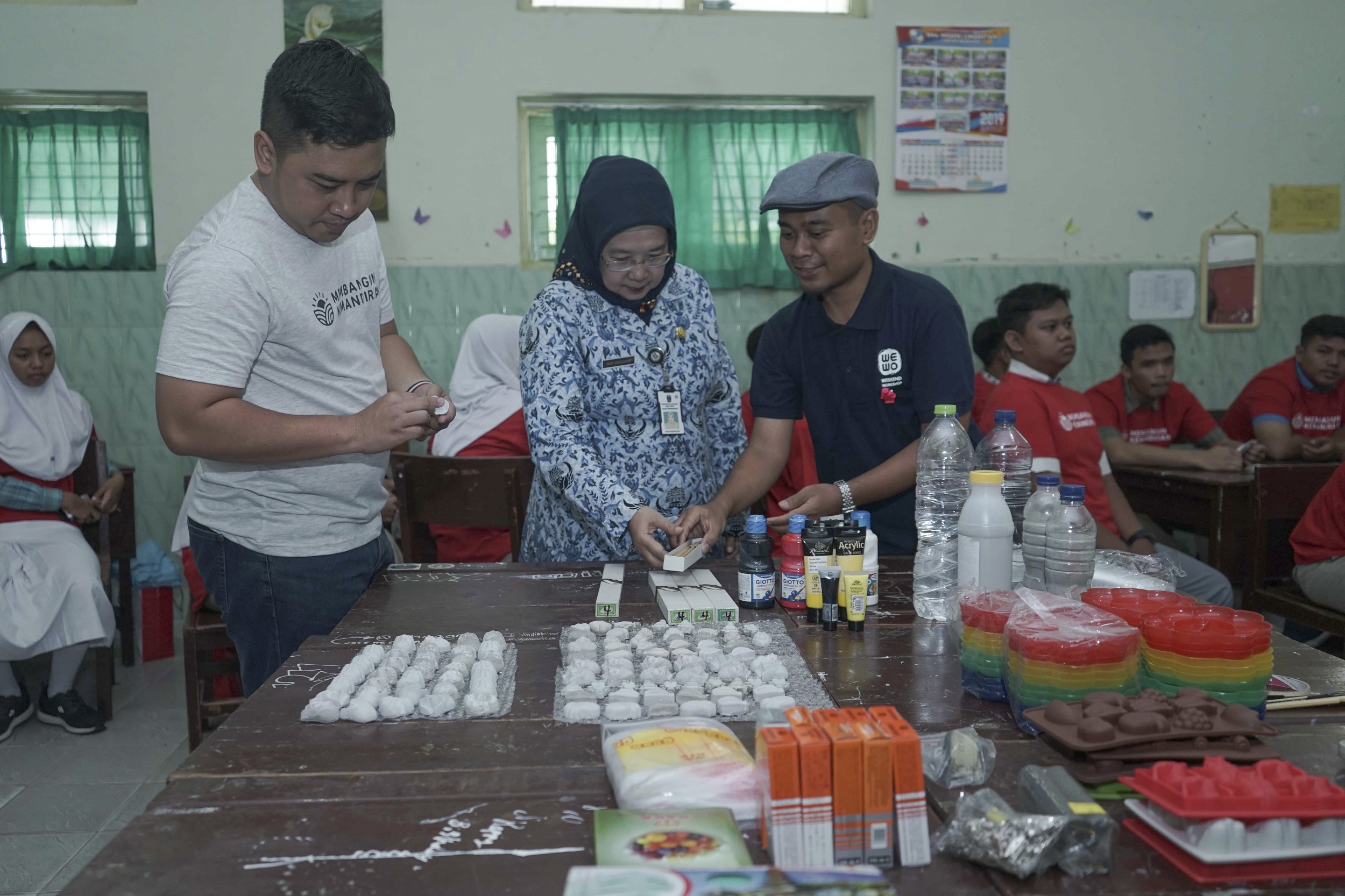 Kepala Departemen Komunikasi Perusahaan Semen Indonesia Sigit Wahono (kiri) bersama Kepala Sekolah SMAN 1 Magetan Dra. Nurhandayani, M.Pd. (tengah) meninjau pelatihan “Creative with Cement” yang diikuti para siswa | 
