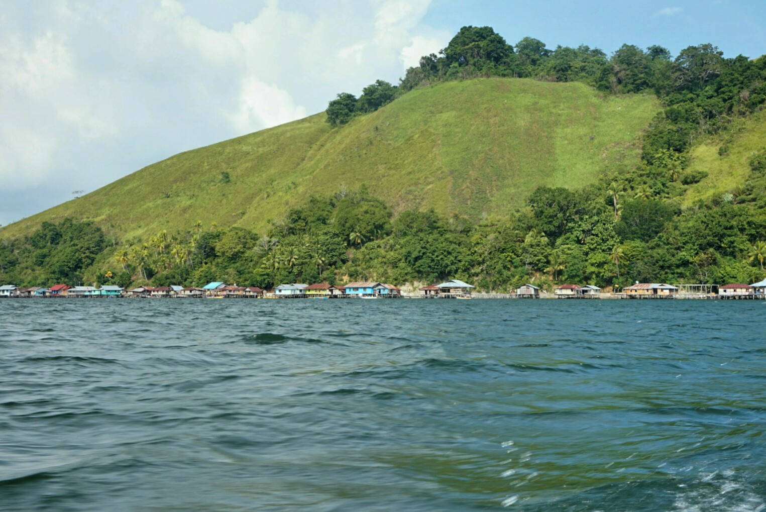 Tampak kampung yang langsung menempel dengan bukit di pesisi Danau Sentani (Foto: Bagus DR / GNFI)